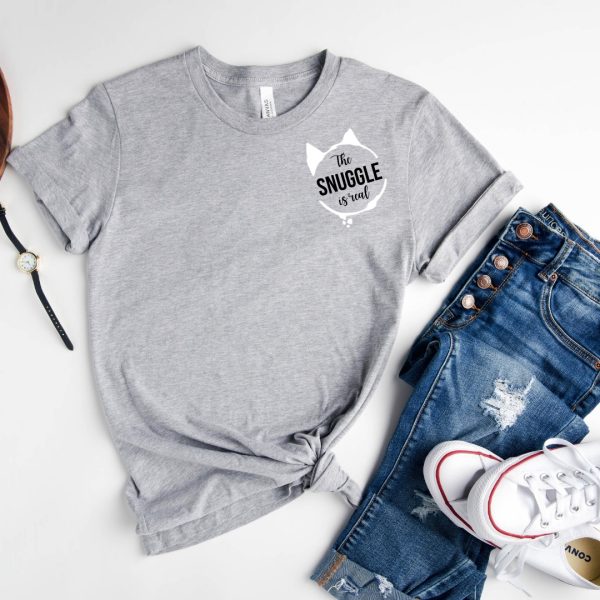 The "The Snuggle is Real T-Shirt (Grey)" with a pair of jeans.