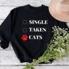 A black Cat Mom sweatshirt for the Cat Moms out there, featuring the phrase "single taken cats".